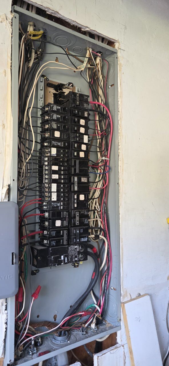 Open 200 amp electrical panel with breakers and wiring