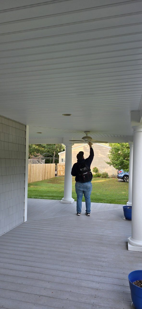 Instructor checking a porch ceiling fan