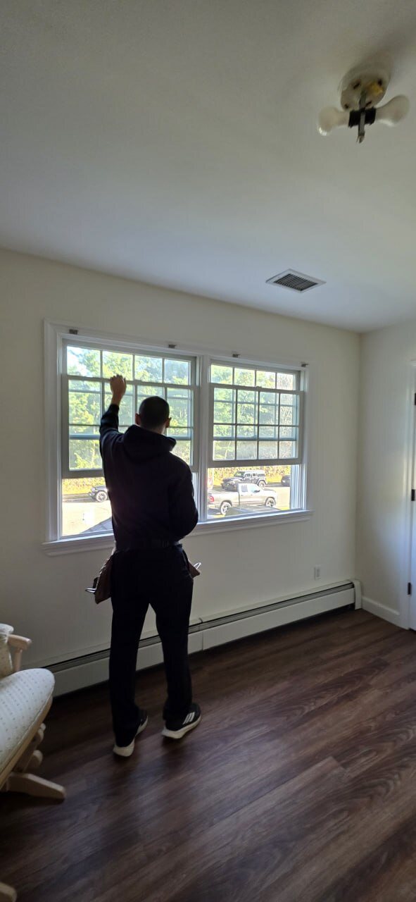 Instructor testing a window inside a home